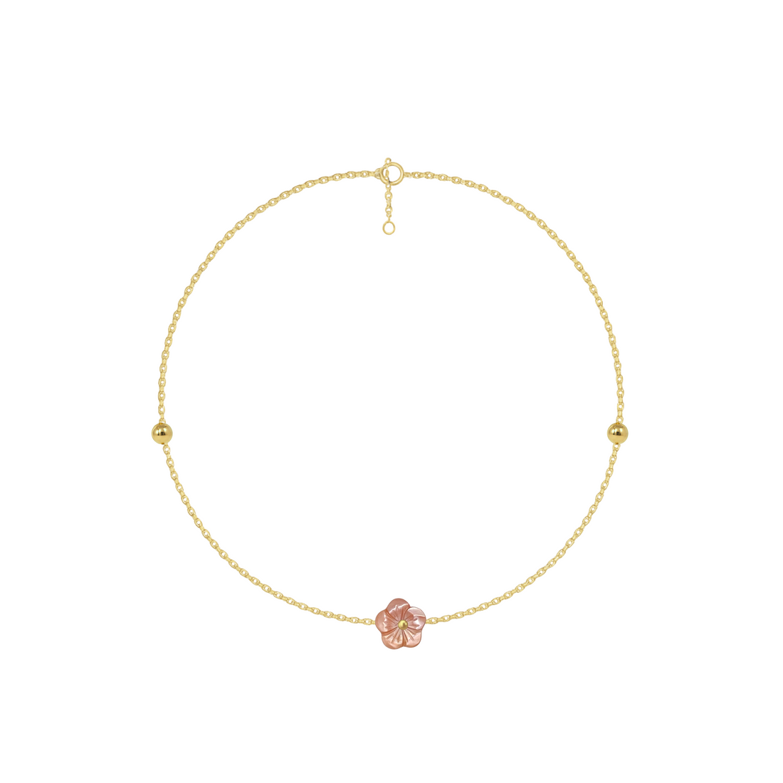 Gold anklet with a pink flower charm on a white background