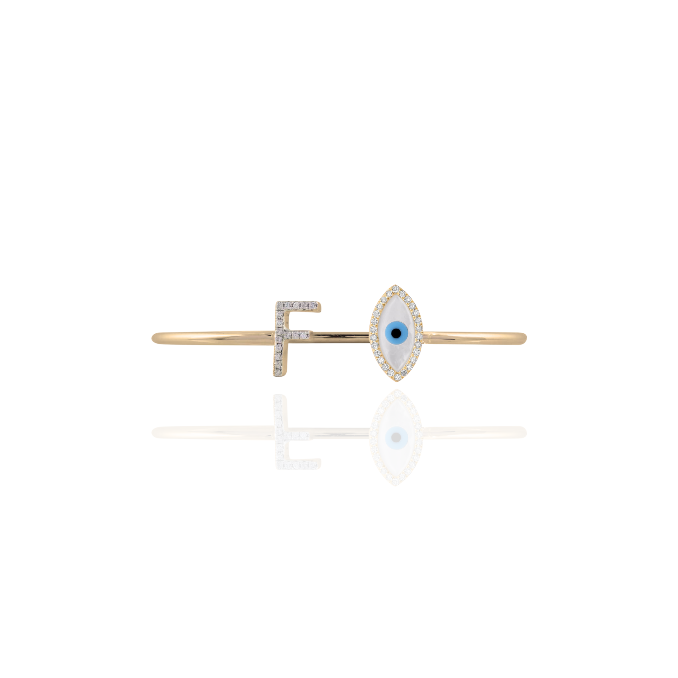 Gold bar brooch with eye design on a white background